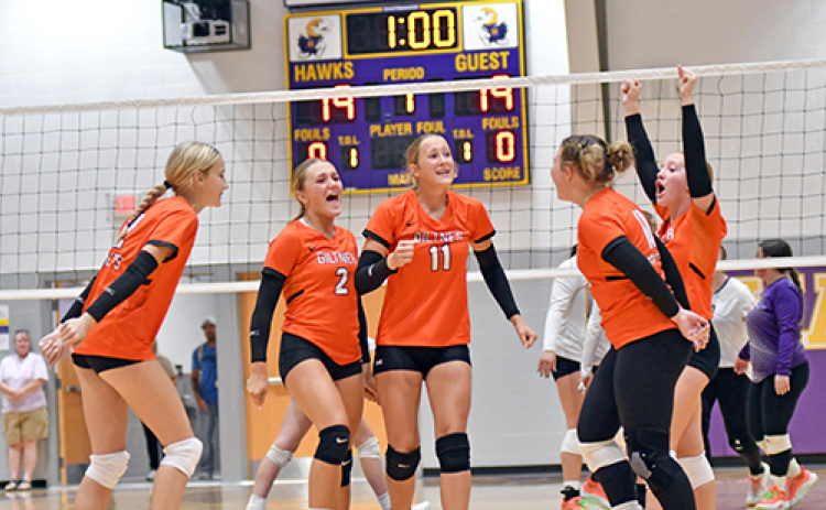 The Giltner volleyball team celebrates a pivotal point late in the first set of the Hornets’ victory over Hampton Thursday night. The Hornets and Hawks played in a triangular alongside Dorchester.