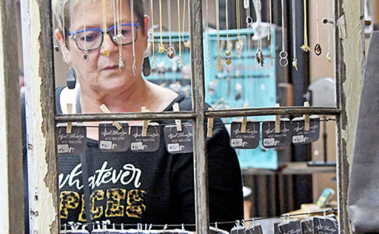 Carrie Sheldon of North Loup, browses the jewelry made by Blue Eyed Bootique.