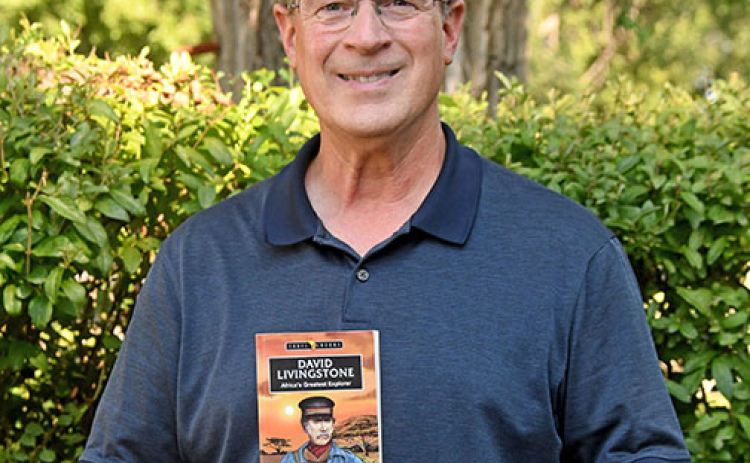 Vance Christie holds a copy of his latest book, “David Livingstone: Africa’s Greatest Explorer”, a biolgraphy of the famous African missionary/explorer for young adults, that will be released Sept. 11.