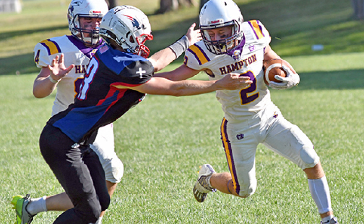 Hampton back Jack Bullis throws a mean stiff arm on his way to a rushing touchdown, one of four on the day and eight TDs in the game.