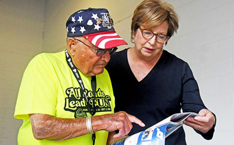 Nebraska State Fair Volunteer Dave Oswald of Aurora assists Liana Steele, wife of Grand Island Mayor Roger Steele, during the fair’s opening day Aug. 23.