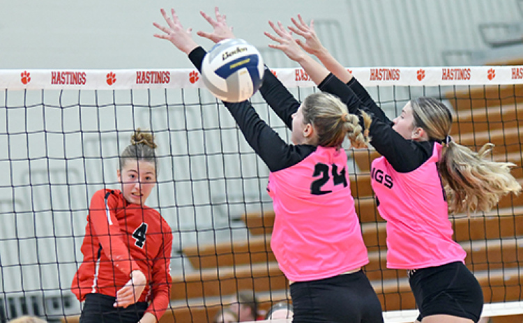 Elizabeth Luebbe sails an attack past two Hastings defenders during Aurora’s four-set win over the Tigers. Luebbe totaled five kills in the match.