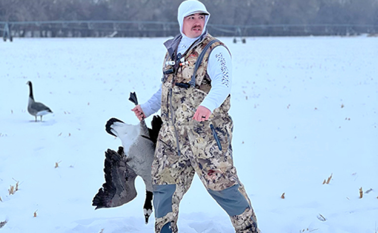 Jeremy Burgener carries one of the geese he downed on a hunting outing last winter.