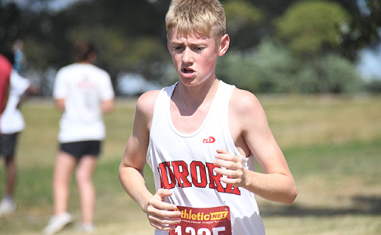 Deagan Handrup pushes himself during the final stretch at the Malcolm Invite finishing the race at 18:51.