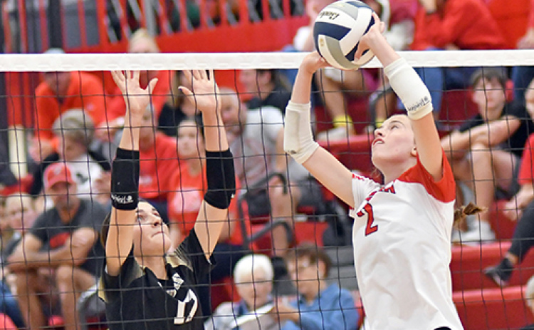 Aurora’s Hailey Hoff sets the offense for the Huskies during a four-set loss to Grand Island Northwest last week.