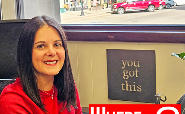 Aurora native Jessica (Vincik) Piskorski sits at her desk in Ord.