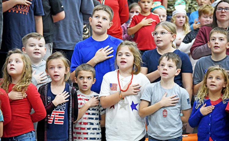 Students from Giltner High School gathered together to celebrate and honor veterans during the school’s annual Veteran’s Day program Monday afternoon. First, fifth and sixth graders stand tall as they say the Pledge of Allegiance.