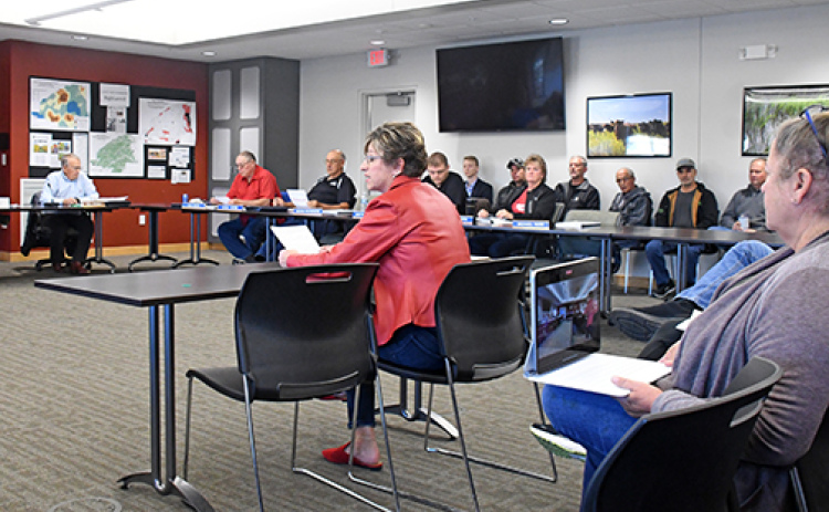 Tina Oswald (right) of Aurora testifies before the Upper Big Blue Natural Resources District on Thursday in opposition to a request by Synergen Green Energy for a two-year extension of its large water user permit, which is set to expire in January.
