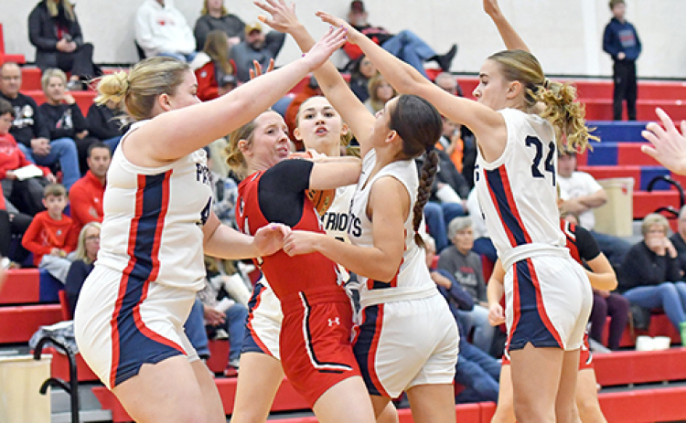 Aurora senior Adi Fahrnbruch is surrounded by four Adams Central defenders during the Huskies’ 36-31 win over the Patriots Thursday, marking the first 1-0 start for Aurora since 2017.