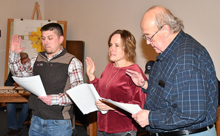 Newly-elected Aurora City Council members taking the oath of office Dec. 10 include, from left:  Mark Dunn, Esther Bergen and Wayne Roblee.