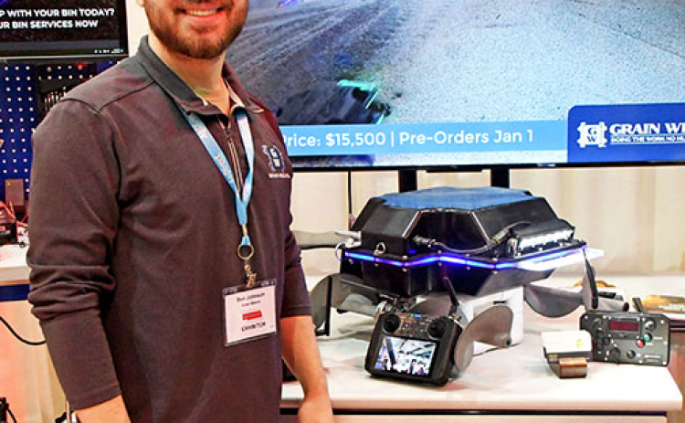 Grain Weevil inventor Ben Johnson stands next to the robot and accessories that will be available for pre-order to farmers beginning Jan. 1.