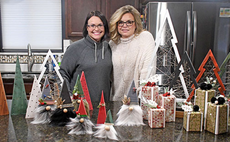 For two years, sisters Heather Nolan (left) and Mandee Lade have been turning their family hobby into a newfound business, R.H. (Ryan and Heather) Crafts, with Nolan’s husband, Ryan, assisting with the woodwork for the trees and flags pictured below.