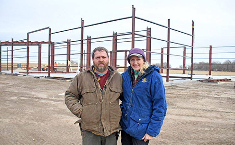 Traver DeMaranville and Beth Wood, co-owners of TC Machine in Phillips, stand on the site where a 17,000 sq. ft. structure is being built on Highway 34 west of Phillips.