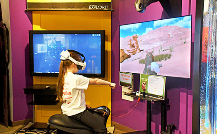 The Edgerton Explorit Center has brought together a horse riding simulator where visitors of all ages can saddle up and experience horseback riding in VR. While visiting the Edgerton on Friday, Dec. 17, Harvard third grader Vivian Kobza takes the reigns rides on the simulator.