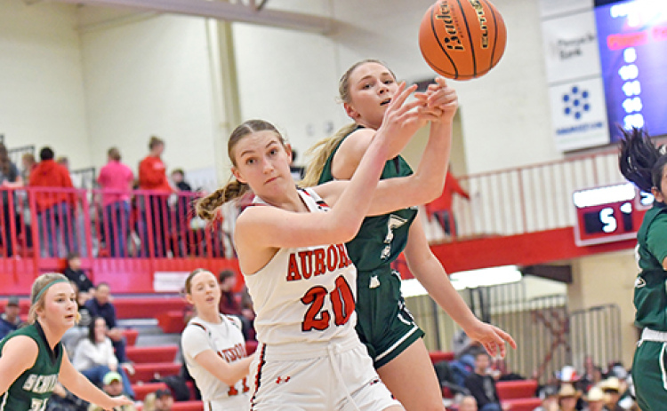 Aurora’s Grace Wieseler battles for the basketball in the paint during the Huskies’ 59-18 win over Schuyler Friday.