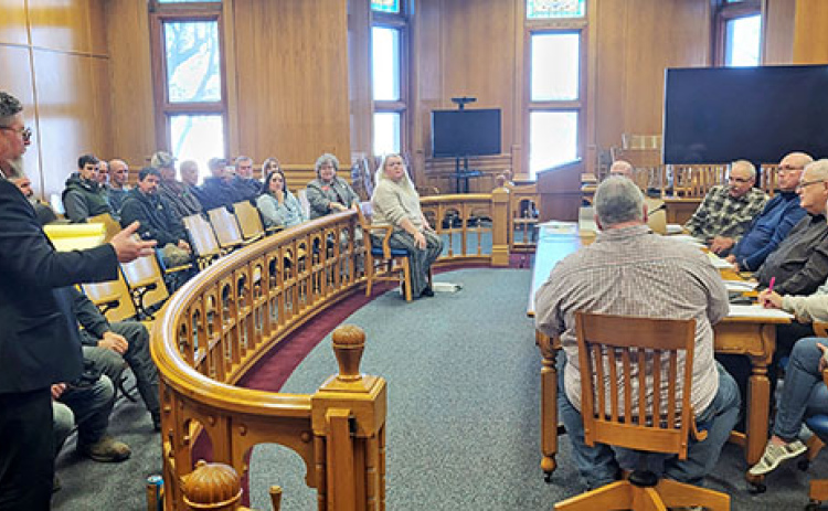 Attorney Stephen Mossman, left, addresses the Hamilton County Board of Commissioners Monday during a public hearing on a conditional use permit for S&P Irrigation. About 20 people attended the hearing, most of whom were in support of the permit.