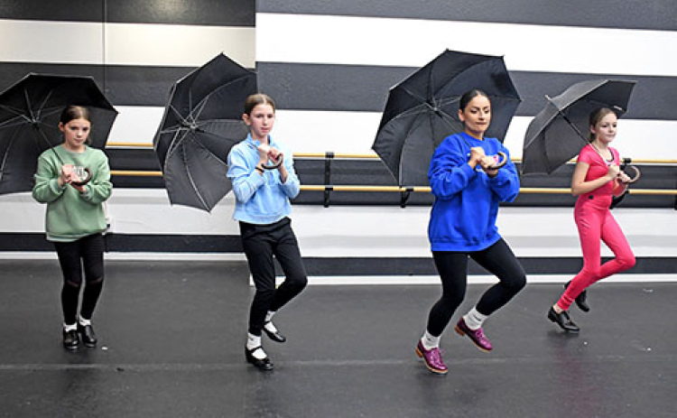 Tempo instructor and owner Ashley Parker (right center) guides her Thursday clogging class through a dance for the upcoming competition season to the song, “Singin’ in the Rain.” Students featured include, from left: Delaney Weedin, Hadley Hudson and Tatum Stevens.