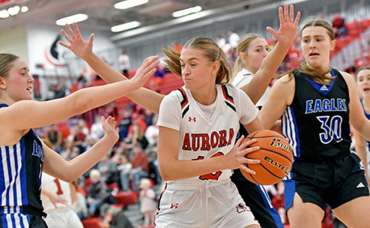 Aurora’s Maddie Ramaekers looks for an open teammate in heavy traffic in the Huskies’ 60-38 loss to O’Neill Saturday.