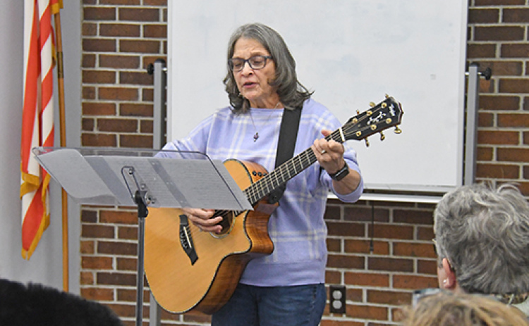 Doris Winkler performs “The Plowshare Song” during a Monday night program celebrating Martin Luther King Day in Aurora.