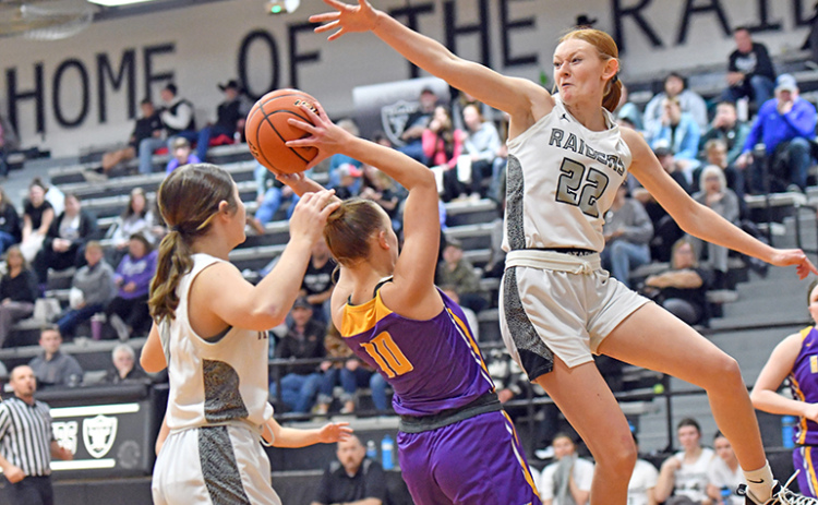 Hampton’s Macy Miller looks for a shot inside the lane between multiple Lawrence-Nelson defenders during the Hawks’ 46-27 loss to the Raiders on the road Thursday.
