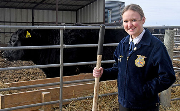 Hampton FFA president Macy Miller stands next to the Hawk Herd corral behind the school. Miller is a booster for beef, agriculture and FFA and plans to attend Northwest Missouri State University this fall to major in ag education, following in the footsteps of both of her parents.