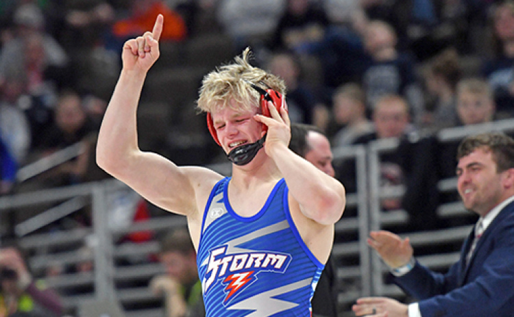 Gage Friesen let some rare emotion come out after his state championship victory while coaches Martin Phillips (right) and Corbey Grause celebrate in the background.