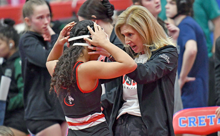 Aurora coach Sheri Thompson shares a few motivational words with Aubrie Beed ahead of her opening match at Saturday’s Central Conference tournament in Crete. Beed finished with a third.
