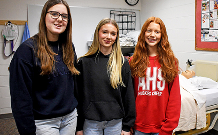 Aurora High School provides a CNA program to train students to become certified nurses aides after completing the certification. Students who are currently taking the course include, from left, Emary Rhoades, Faith Utley and Ellie Brown.