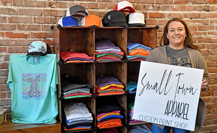 Christine (Holliday) Bruner is the owner and designer of Small Town Apparel in downtown Aurora. Bruner offers custom prints as well as local school, business and Nebraska wear at her new location at 1123 13th St.
