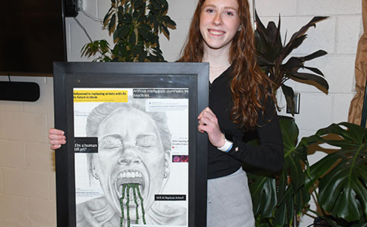 Aurora junior Kendal Wineteer poses with an art piece she created which earned her a Nebraska Young Artist Award from the University of Nebraska-Lincoln’s Hixson-Lied College of Fine and Performing Arts.