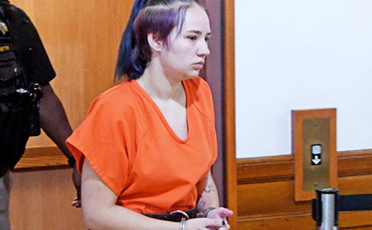 Tiffany Cure steps off the elevator on the top floor of the Hamilton County Courthouse last August for her initial court appearance on charges of child abuse resulting in death.