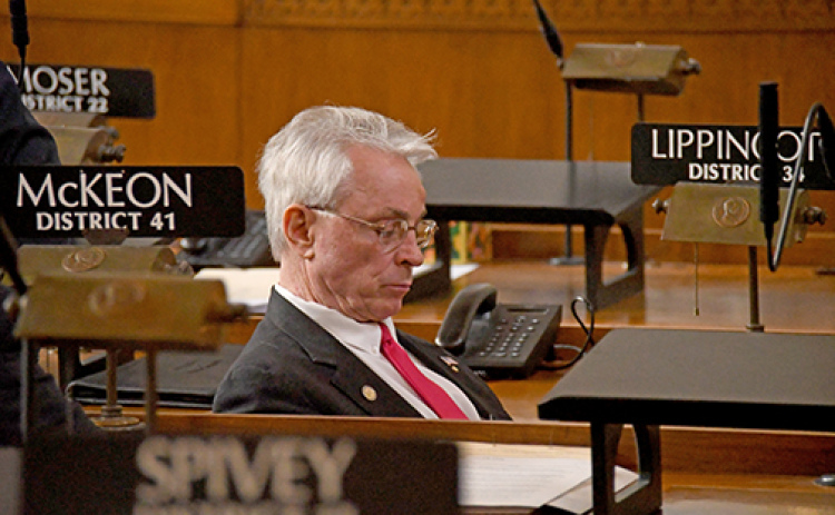 Sen. Loren Lippincott sits in his desk on the floor of the Nebraska Senate.