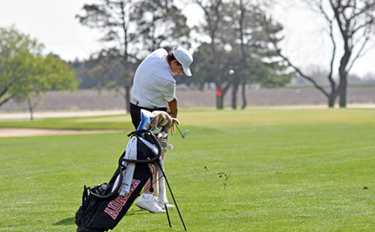 Aurora freshman Cash Garrett hits his approach shot into the par-4 fifth hole where he ended up with par. Garrett eagled his final hole to shoot 75 and finish ninth overall for his first varsity medal.