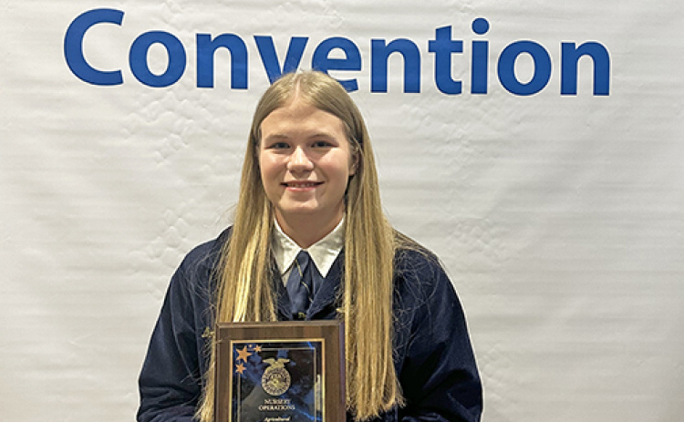 Morgan Bonifas displays the Nursery Operations Agricultural Proficiency Award she was presented at the Nebraska State FFA Convention earlier this month. She received the award for her high school summer job at Wild Roots Greenhouse in Central City.