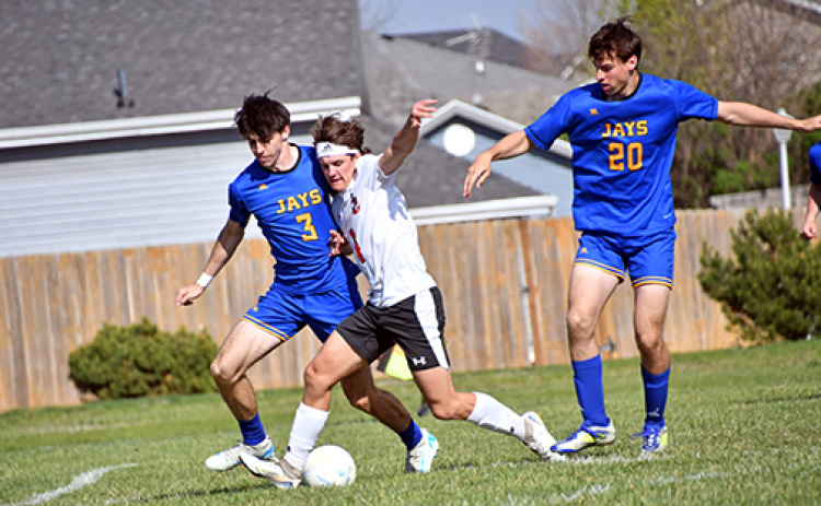 Canon Allen breaks through a pair of Seward defenders during last week’s 1-0 loss to the Jays. Allen’s potential equalizer in the final seconds was just off the mark.