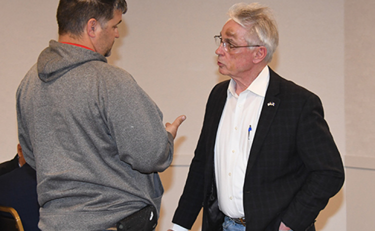 Dist. 34 Sen. Loren Lippincott (right) visits with local resident Justin Elge at the town hall forum he held in Aurora on Friday