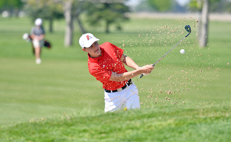 Keelan Phillips digs his way out of the sand on the opening hole at Jackrabbit Run in Grand Island, eventually carding an 84 as part of Aurora’s efforts in Friday’s Central Conference meet.