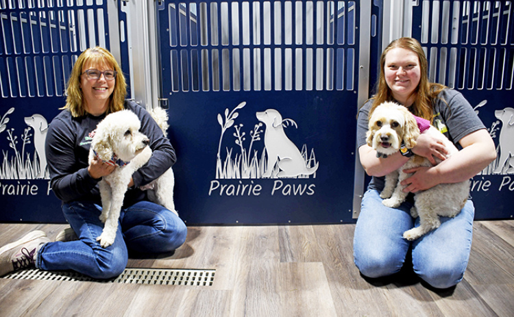 Prairie Paws is a family-owned dog grooming business west of Marquette run by mother Amy (left) and daughter Logan Nissen. The business also provides cremation services for families. Posing alongside Logan and Amy are Tucker and Tellula.