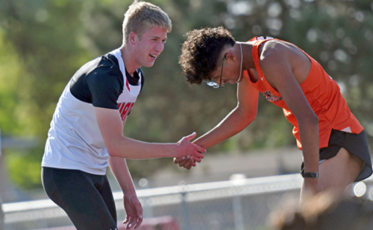Aurora’s Charlie Evans shows great sportsmanship with Lexington’s Herson Rodriguez after the Husky won the 800 meter run at last week’s B-5 district meet.