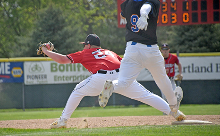 Tate Bendorf reaches out to get the out at first base for the Huskies during a 13-3 loss to St. Paul/Palmer at Mitchell field Thursday. Aurora will play Fort Calhoun to open up the C-4 district Thursday.