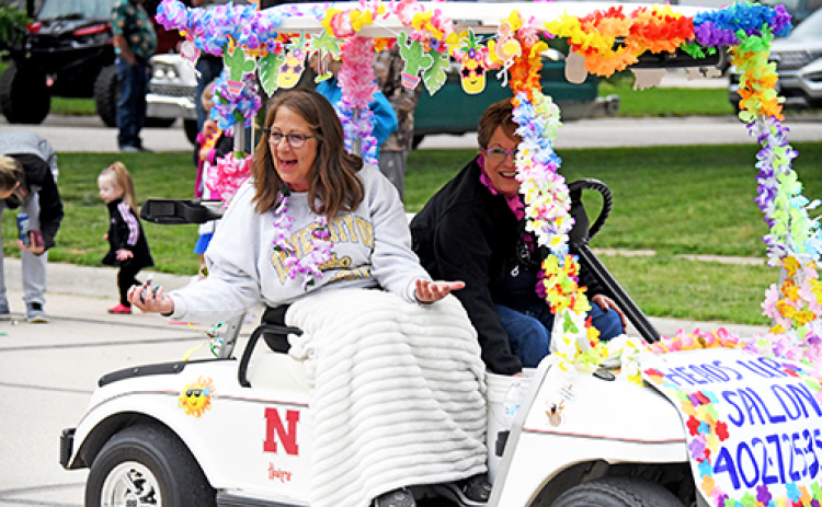 This Booster Days entry was decorated by Heads Up Salon. Cindi Ratzlaff is driving, with Carrie Begley reflecting the feel-good vibe of the grand parade.