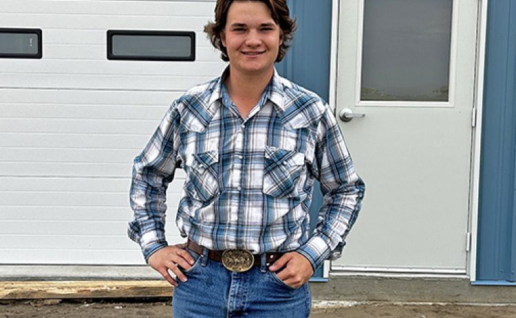 Cooper Kremer stands in front of the new home of UAM Systems, located at the Aurora airport.