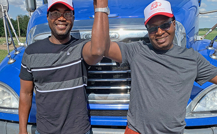 Wallace Mucherengi and Gilbert Chisvo celebrate earning their CDLs through IWS in 2022. Both went on to drive for a Salt Lake City company.