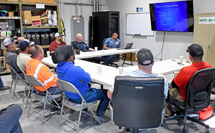 Members of local law enforcement, emergency service agencies and others participate in a public awareness and safety training exercise at the Koch Fertilizer anhydrous ammonia storage facility west of Aurora on Tuesday, June 10. Leading the session at top right is Facility Manager Tony Roth.