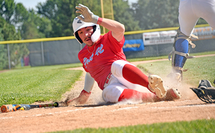 Pinnacle Bank Post 42 Seniors center fielder Keegan Chaney slides into home for a run during Aurora’s 13-3 loss to Gering Thursday.