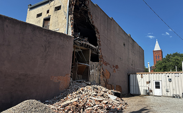 Bricks falling from the north wall of the former Gambles building prompted city officials to close the back alley after the damage was discovered early Thursday morning.
