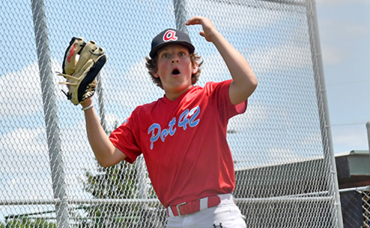 Landen Hansen reacts to a safe call at the plate during a home game earlier this season for the Aurora Cooperative Juniors squad.