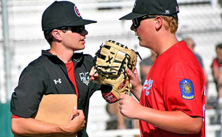 Aurora’s Tate Bendorf, pictured here with Juniors coach Jarrett Havens, tossed a complete game in a 12-4 win over Grand Island.