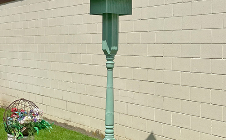 Craftsman Roger Merchant reused an old porch post that Shirley Schacht had kept from her porch when it was renovated in 2019.