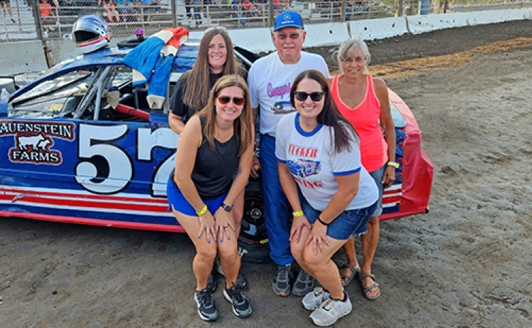 Retired late-model racer Kent Tucker (center) competed in the 2025 Legends of Lex race at the Dawson County Raceway in Lexington on Sunday, Aug. 10, where he placed second out of eight drivers. Tucker poses for a picture after the hot laps surrounded by his members of his family. Picture in front, from left, are daughters Jessica Rojewski and Megan Rathje. In back are daughter Libby Spotanski and Tucker’s wife, Laura.